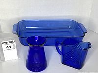 Overall view of baking dish, creamer, and vase