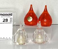 Front view showing two orange and two clear tear-drop shakers; gold Guzzini label visible