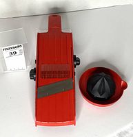 Top view of mandolin slicer and juicer bowl with reamer