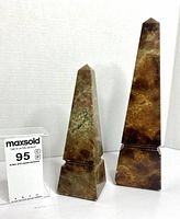 Front view of both agate obelisks showing size difference and veining