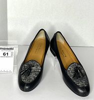 Full view of both shoes showing leather and tweed construction