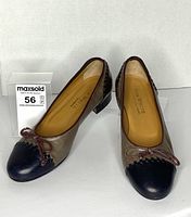 Front view of both Ron White shoes showing cap toes, bows, stitching