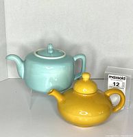 Front view of both teapots showing shape and color