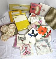 Full lot showing variety of stationery sets, doilies and napkin packs
