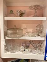 All glassware pieces arranged on three shelves