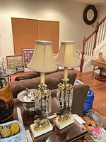 Full view of both brass and marble luster lamps on table