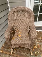 Front view of wicker rocking chair on deck