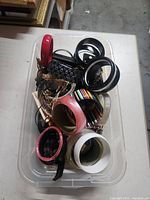 Top view of tote showing mix of bangles, cuff and chains