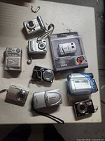 Front view of all cameras and sealed Vivitar package on table