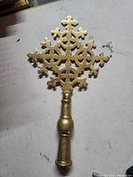 Front view of brass Ethiopian cross