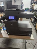 Front view of HP Officejet Pro X576dw showing touchscreen, paper trays and overall condition