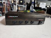 Front view showing Monster Cable branding and five selector buttons