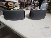 Front view of both Bose speakers on table