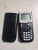 Front view of TI-84 Plus calculator alongside slide cover