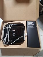 Base unit, RJ11 cable and packaging insert visible inside box