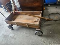 Full view of wooden wagon with handle extended and all four wheels visible