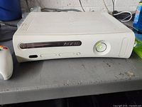 Front view of Xbox 360 console and part of controller