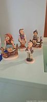 Group shot of all four porcelain child figurines