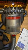 Canister vacuum body with clear bin showing model name