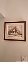 Full view of framed winter landscape painting on wall