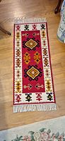 Full view of kilim-style runner rug on hardwood floor
