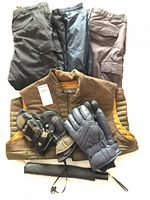 Full lot overview showing vest, three snow pants, three glove pairs, and fabric sleeve