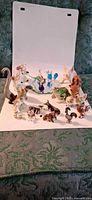 Group view of all 13 animal figurines and mirrored base