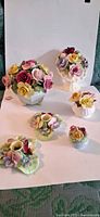 All six porcelain floral pieces grouped