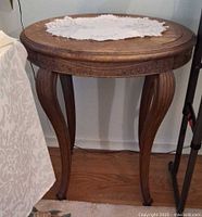 Full view of round side table with lace doily on top