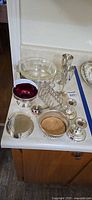 Group overview of all silver-plated pieces on countertop