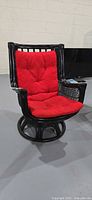 Full view of the swivel rocker armchair with red cushions installed