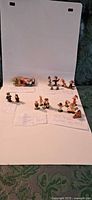 All eleven Marx Tinykins figurines grouped on white background