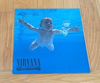 Front album cover featuring underwater baby artwork