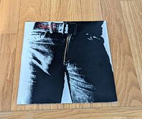 Front sleeve showing jeans artwork and metal zipper