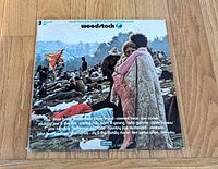 Front gatefold cover showing festival crowd and embracing couple