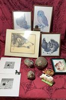 Group shot of all framed prints, photographs, tin animals and ceramic piggy banks