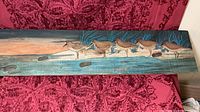 Full view of painted wood plank showing entire beach bird scene