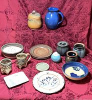Group shot of all ceramic pieces on red cloth background