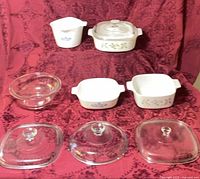 Group shot of all four casseroles, glass bowl and three lids