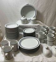 Full assortment of plates, bowls, mugs, covered pieces displayed