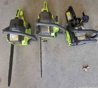 Top view of three Poulan chainsaws showing bodies, bars, controls