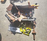 Top view of tote showing assorted saws, hatchets and blades