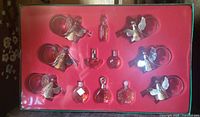 Front of unopened Eaton boxed set showing eight angel napkin rings and eight miniature perfume bottles