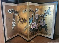 Full view of four-panel screen opened showing artwork