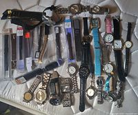 Group shot of all watches and packaged bands spread on mattress