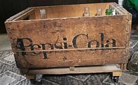 Front view of Pepsi-Cola crate on casters