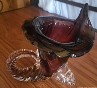 Oblique view showing purple cornucopia vase with clear twisted base