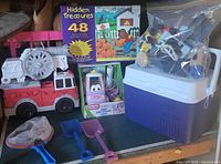 Overview of firetruck, puzzle, mini coupe, sand tools, train parts bag