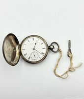 Open sterling silver pocket watch with winding key