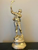 Front view of bronze pruner figure on base